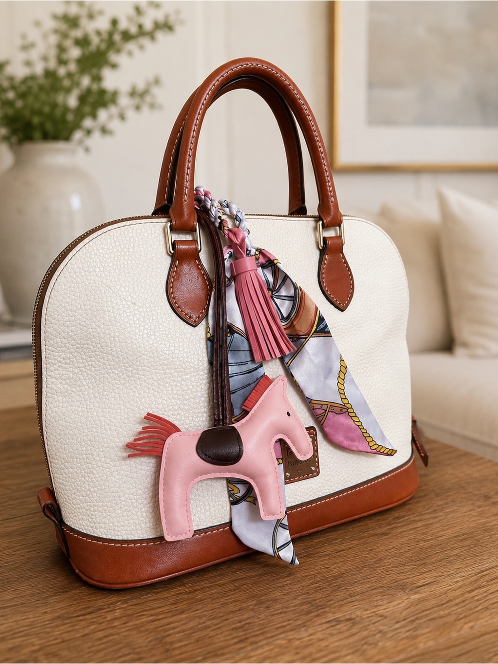 Dooney & Bourke Cream and Brown Dome Handbag with Pink Horse Charm